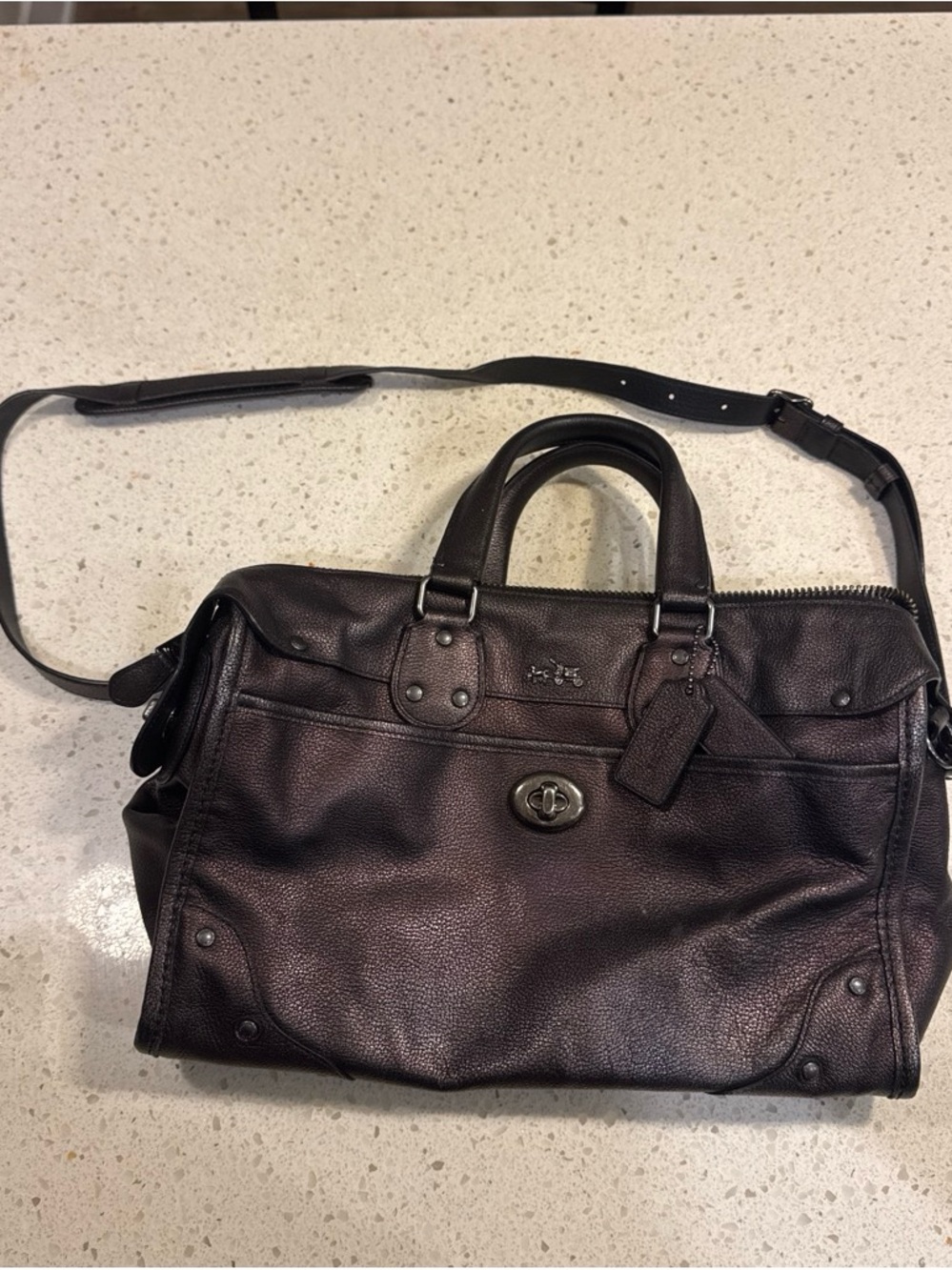 Coach Rhyder Satchel crafted in a textured bronze leather with dark hardware